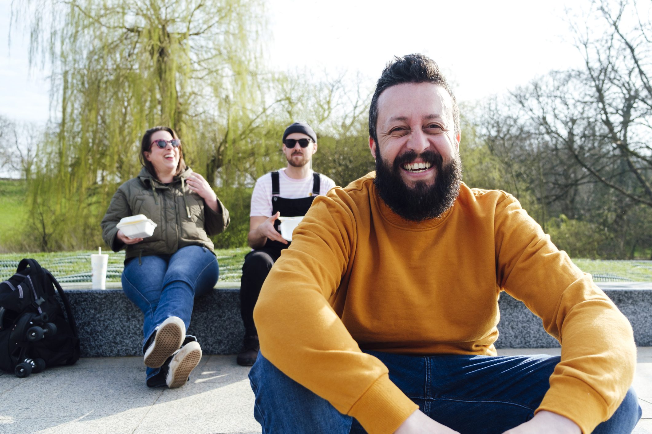 group of adult friends sharing lunch outside